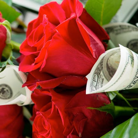 A bouquet of roses mingling with cash